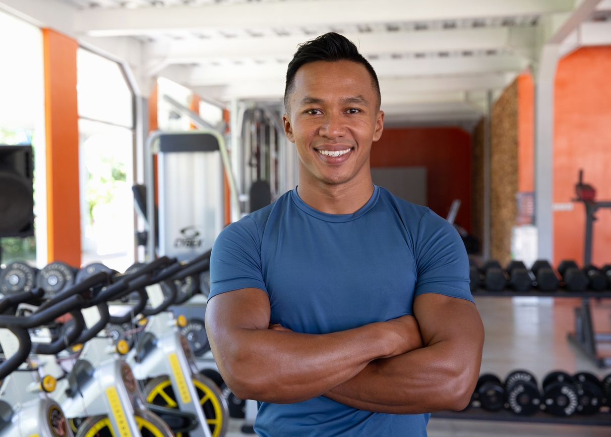 Confident Personal Trainer At Gym
